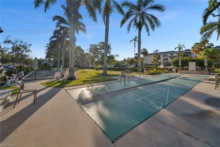 Surrounding community with shuffleboard and a patio area