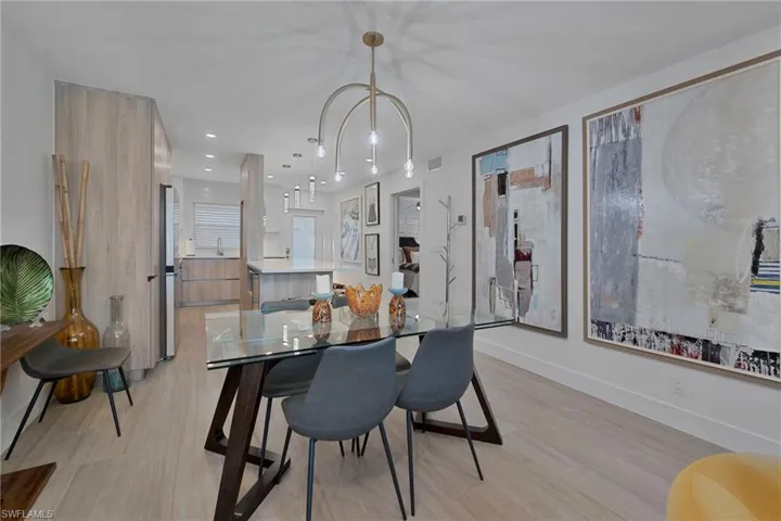 Dining space with recessed lighting and light wood-style flooring