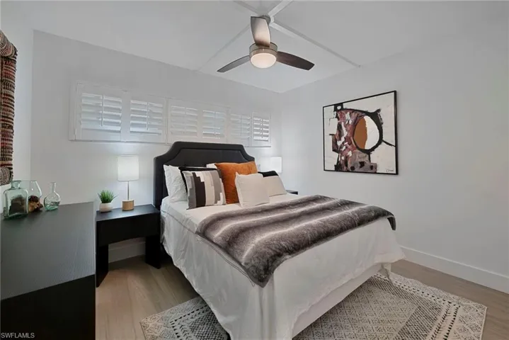 Bedroom with light wood finished floors and ceiling fan