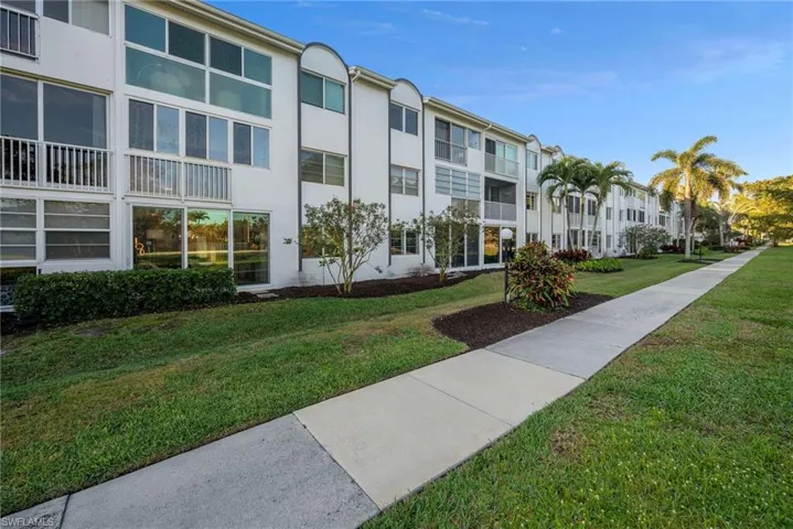 View of home's community with a lawn