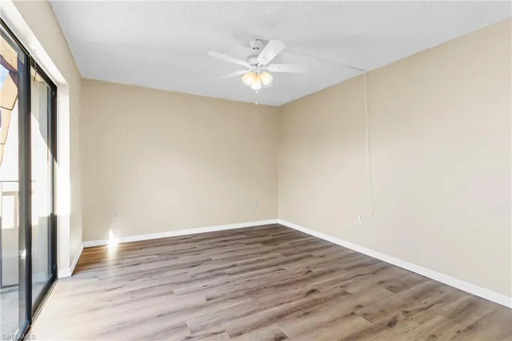 Unfurnished room with ceiling fan, a textured ceiling, and light hardwood / wood-style flooring
