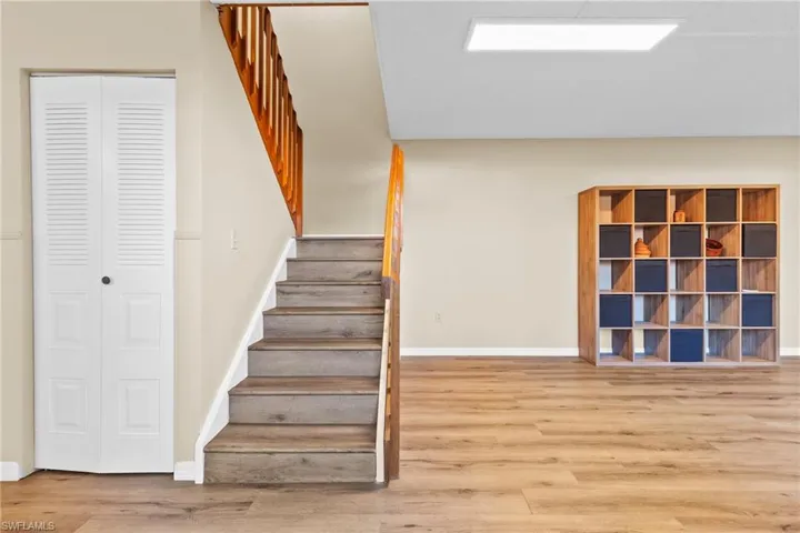Staircase featuring hardwood / wood-style flooring