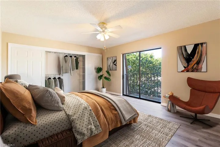 Bedroom featuring light hardwood / wood-style flooring, ceiling fan, access to outside, and a textured ceiling