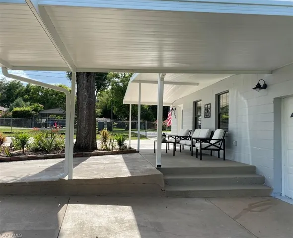 View of patio / terrace featuring fence and a porch