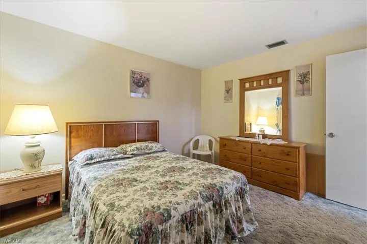Bedroom featuring light colored carpet