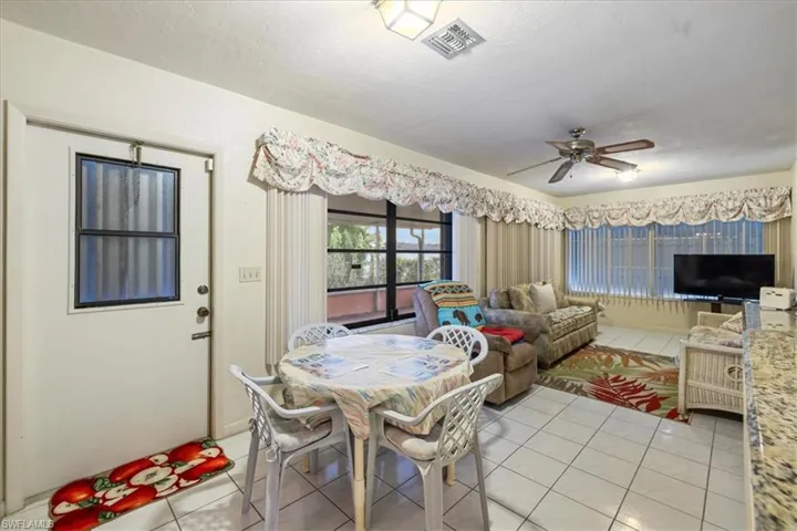 Dining area featuring ceiling fan and light tile patterned floors