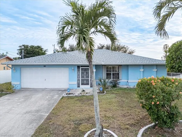 Single story home with a front yard and a garage