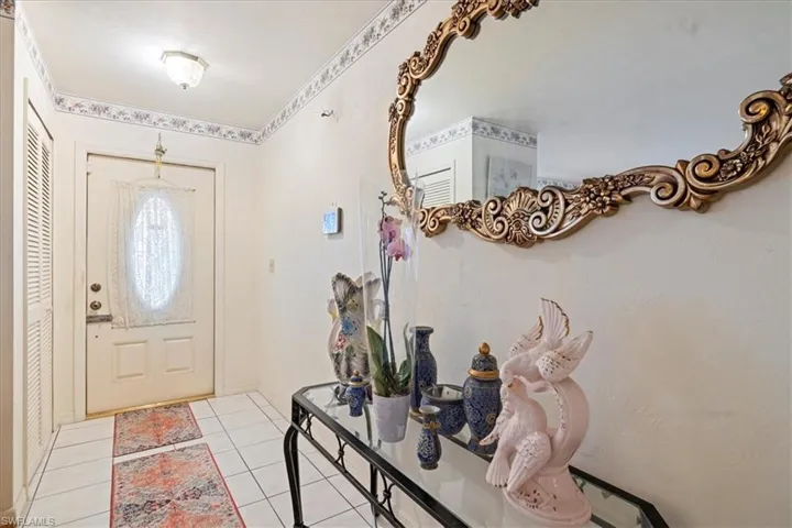 Foyer featuring light tile patterned floors