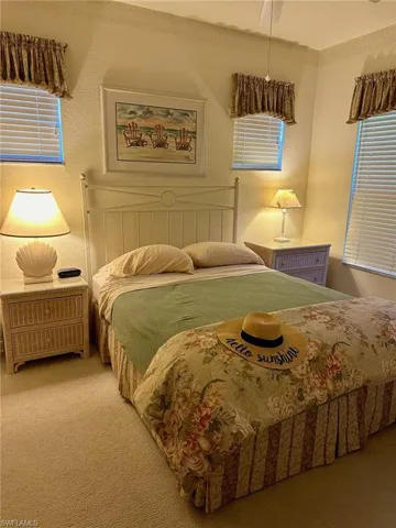Carpeted bedroom with ceiling fan