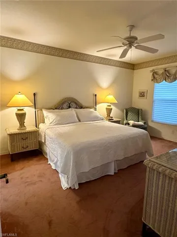 Carpeted bedroom with ceiling fan