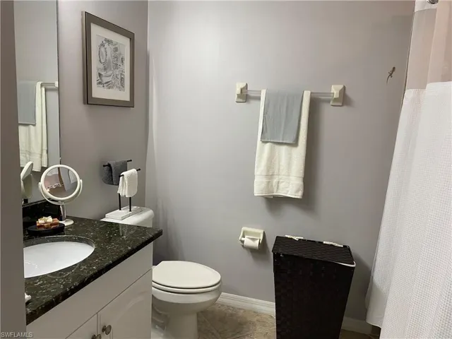 Bathroom with tile patterned floors, vanity, and toilet