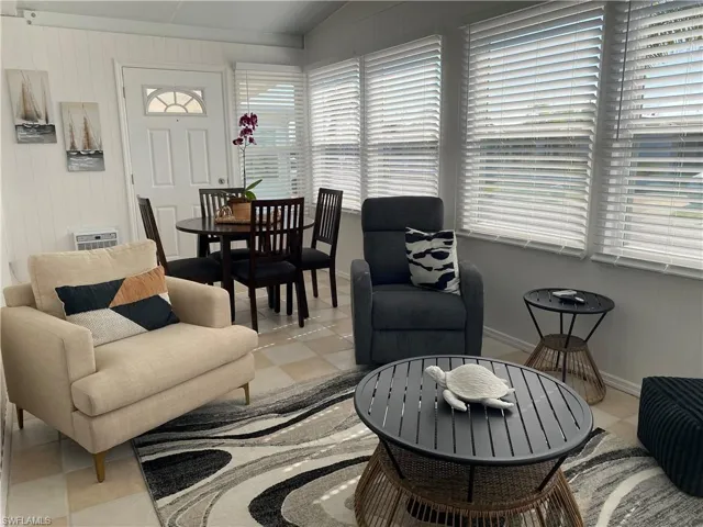 Living room featuring lofted ceiling and light tile patterned flooring