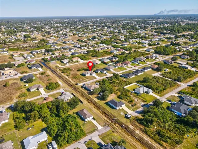 Aerial view of property's location with nearby suburban area