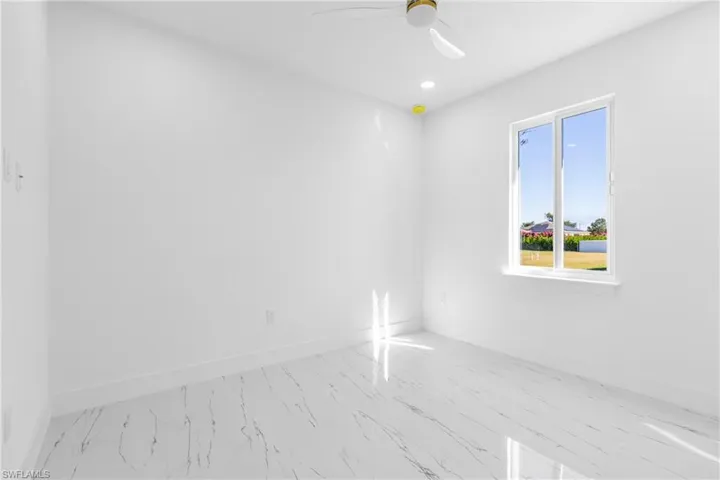 Spare room with recessed lighting, a ceiling fan, and marble finish flooring