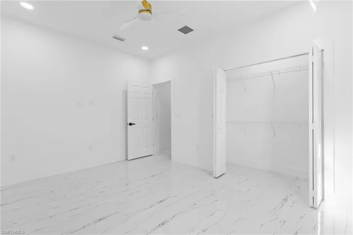 Unfurnished bedroom with ceiling fan, recessed lighting, and a closet