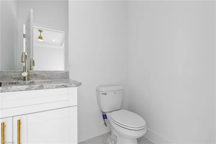Bathroom featuring vanity and marble finish flooring