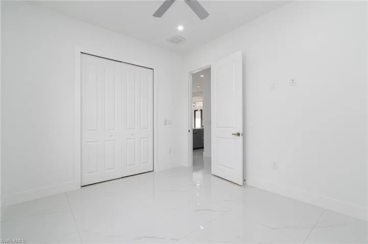 Unfurnished bedroom featuring recessed lighting, a closet, ceiling fan, visible vents, and baseboards