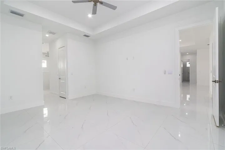 Unfurnished room featuring recessed lighting, visible vents, ceiling fan, and baseboards