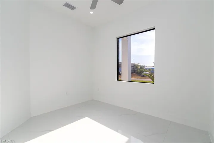 Spare room featuring visible vents, ceiling fan, baseboards, recessed lighting, and marble finish floor