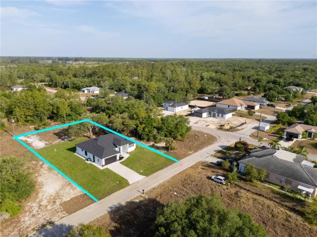 Birds eye view of property featuring a wooded view and a residential view