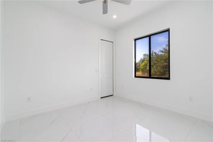 Spare room with recessed lighting, marble finish floor, ceiling fan, and baseboards