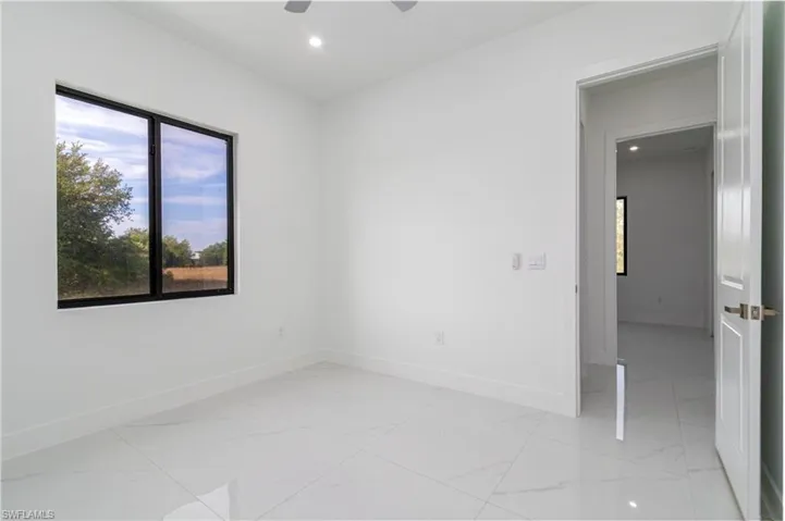 Empty room with recessed lighting, a ceiling fan, marble finish floor, and baseboards