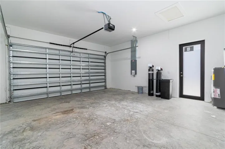 Garage with a garage door opener and electric water heater