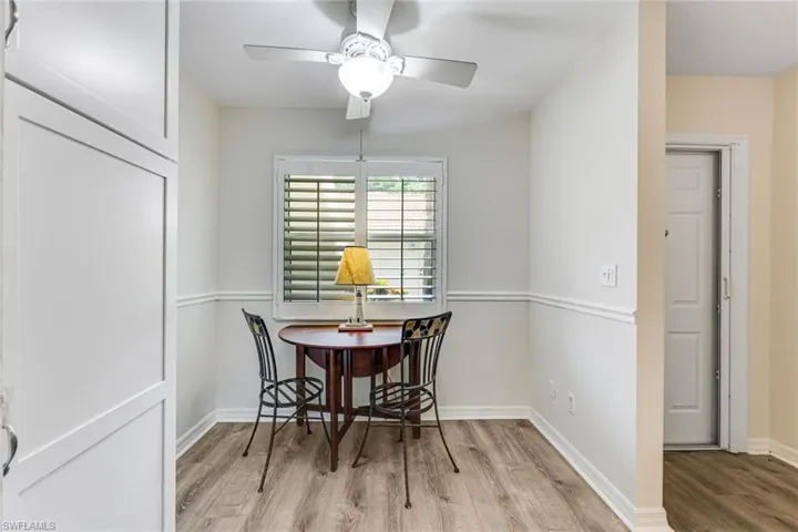 Dining area featuring wood-finish flooring and a ceiling fan with integrated lighting