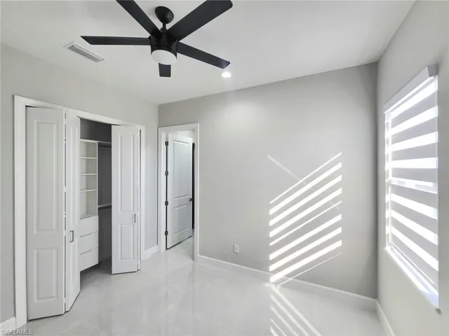 Unfurnished bedroom featuring ceiling fan, a closet, and recessed lighting