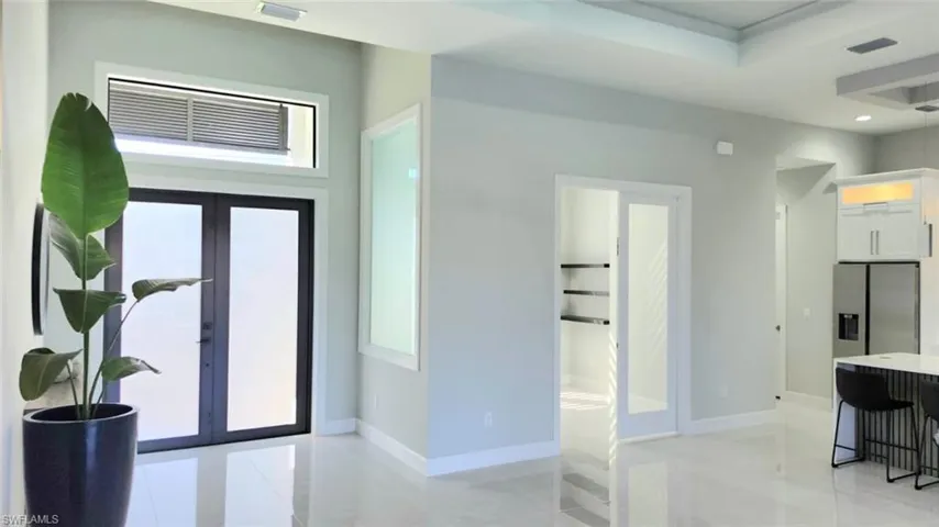 Foyer entrance with french doors and recessed lighting