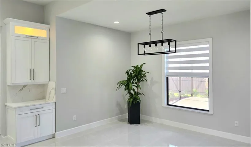 Unfurnished dining area with recessed lighting and light tile patterned floors