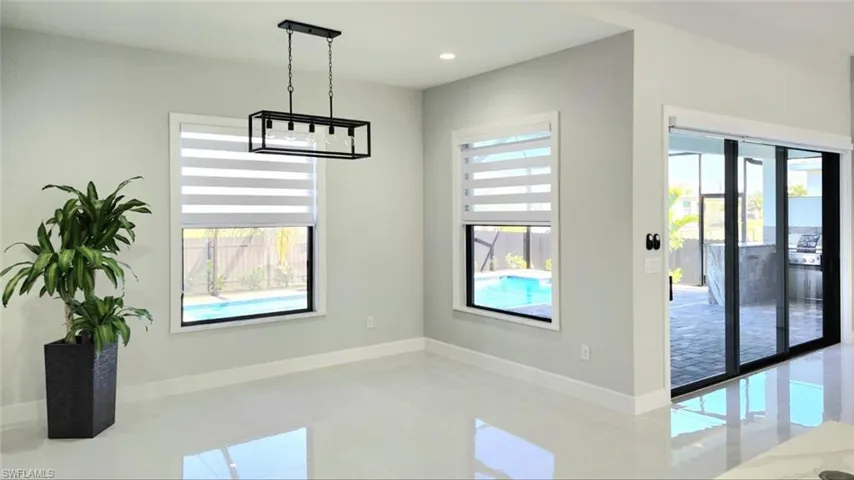 Unfurnished dining area featuring baseboards and recessed lighting