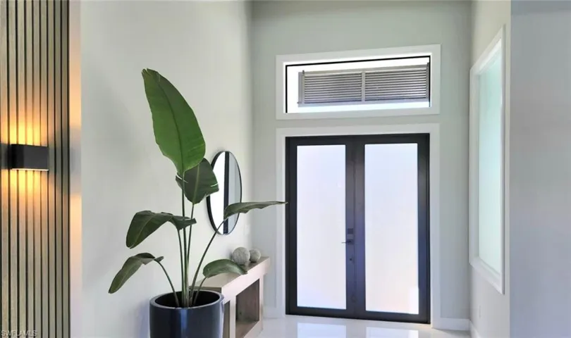 Foyer featuring french doors and healthy amount of natural light