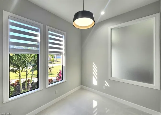 Empty room with baseboards and recessed lighting