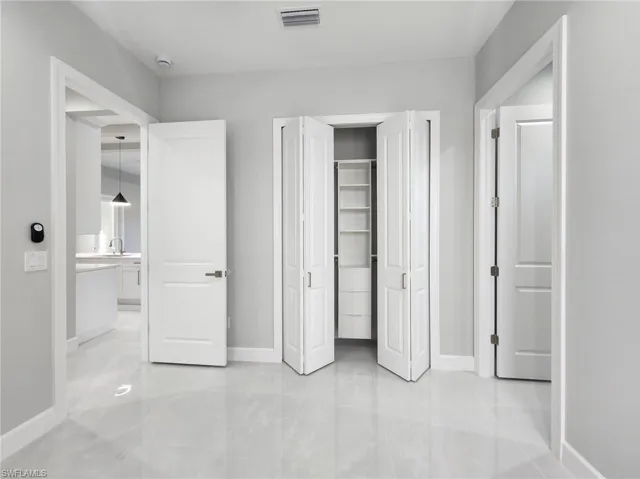 Unfurnished bedroom with baseboards and a closet