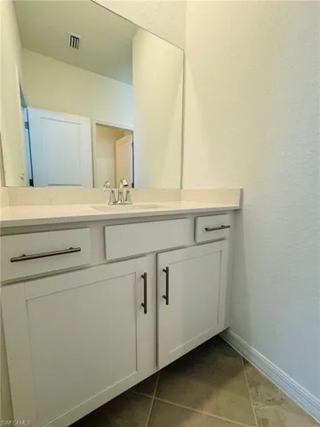 Bathroom featuring vanity and tile patterned flooring