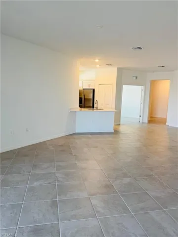 living room featuring sink and light tile patterned floors