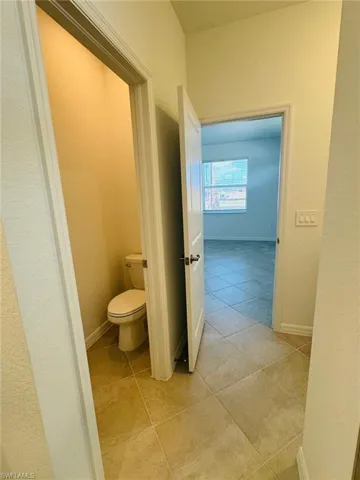 Bathroom with water closet and tile flooring