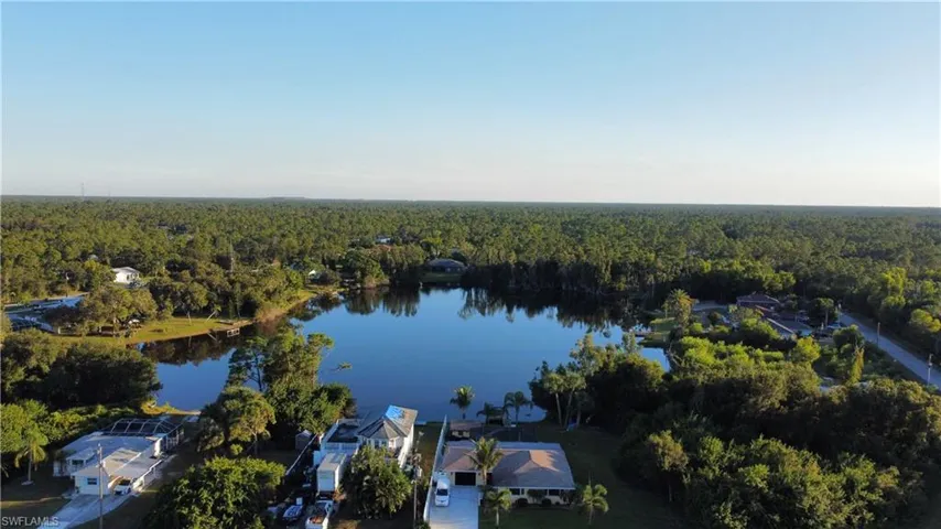 Bird's eye view of a heavily wooded area and a nearby body of water