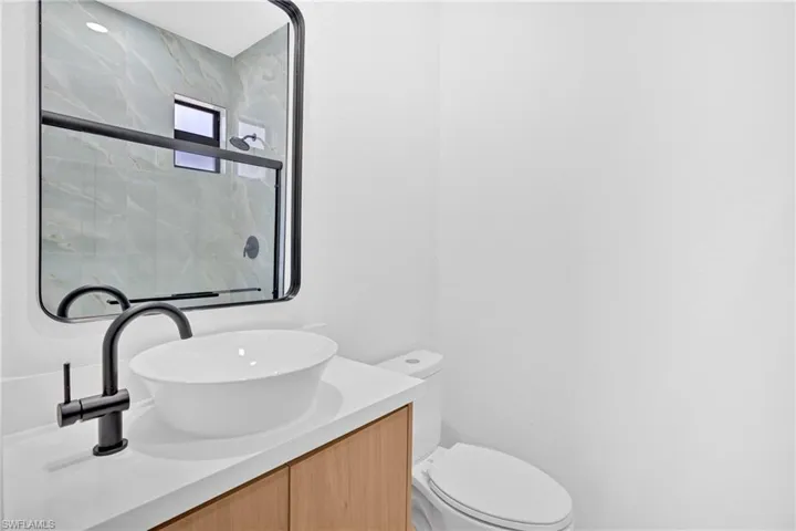 Bathroom featuring vanity and a shower