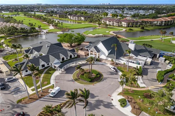 Birds eye view of property with golf course view, a water view, and a residential view