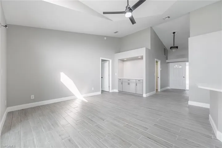 Unfurnished living room with baseboards, visible vents, and light wood-style flooring