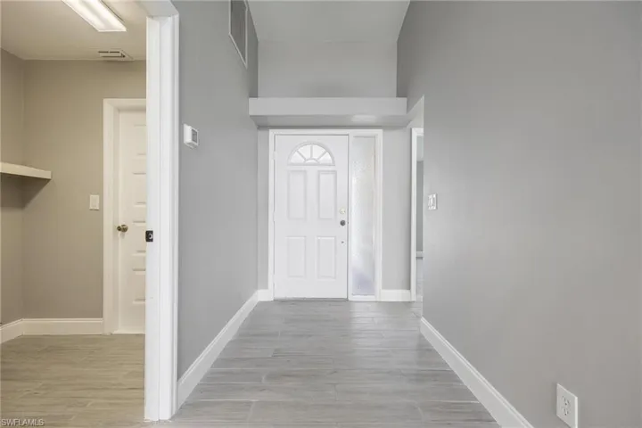 Entryway with baseboards, visible vents, and light wood finished floors
