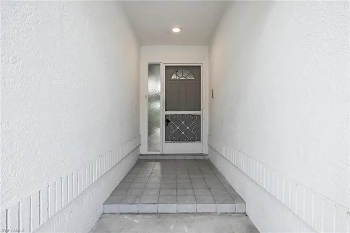 View of exterior entry featuring stucco siding