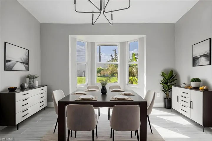 Dining space featuring a chandelier and baseboards