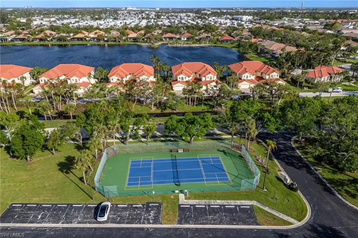Birds eye view of property featuring a water view and a residential view