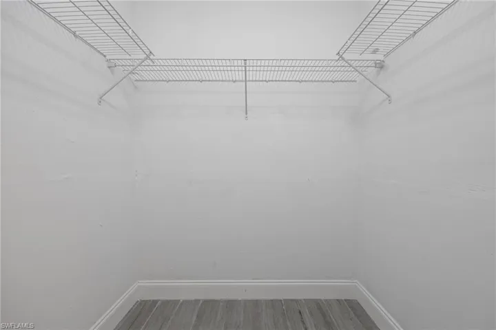 Walk in closet featuring wood finished floors