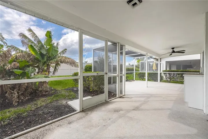 Unfurnished sunroom with ceiling fan and visible vents