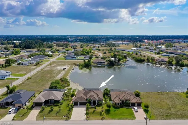 Birds eye view of property with a water view