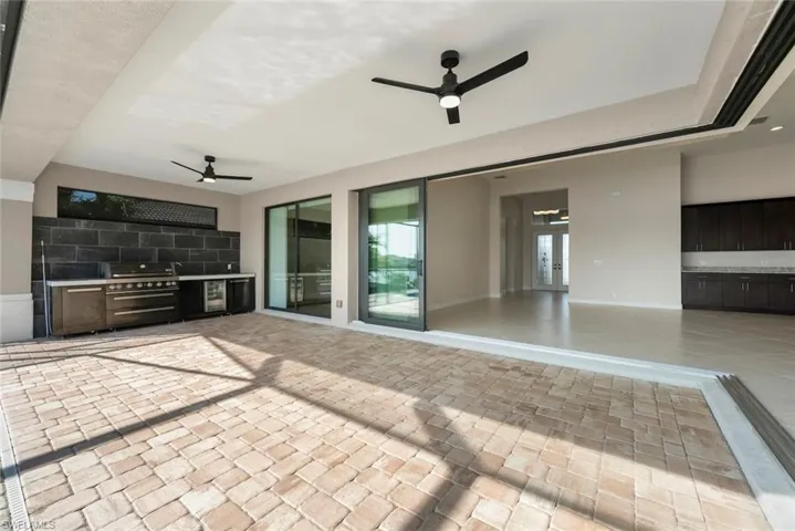 View of patio featuring area for grilling and ceiling fan